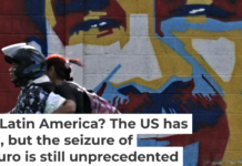 A motorcycle rides past graffiti depicting Venezuelan President Nicolas Maduro in Caracas on Jan. 3, 2026. Juan Barreto/AFP via Getty Images